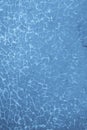 Shattered glass pane in blue, covered in small cracks. Royalty Free Stock Photo